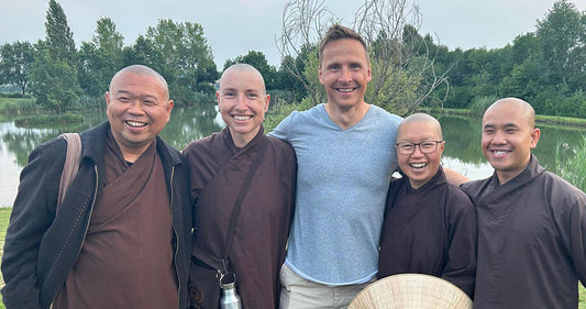 Bjorn and a group of people standing in front of a scenic mountain view