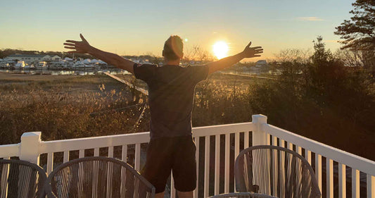 bjorn with his hand spread open looking into the sunrise