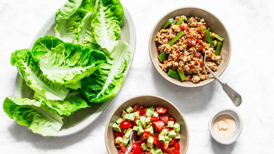 Ingredients for lettuce wrap - romaine, grounded chicken teriyaki, tomato, avocado salad on a light background, top view