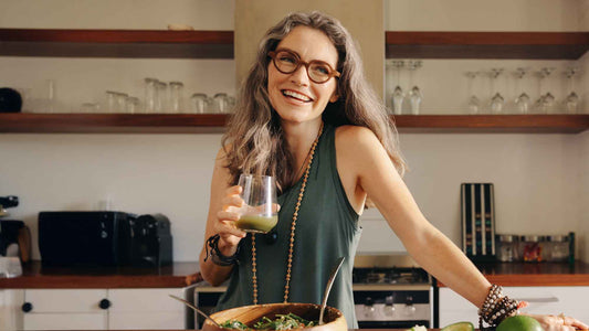 Woman enjoying a green smoothie and healthy meal as part of a daily routine supporting gut health and digestion
