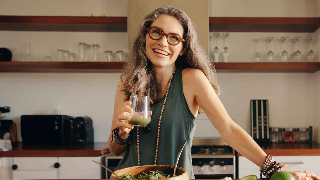 Woman enjoying a green smoothie and healthy meal as part of a daily routine supporting gut health and digestion