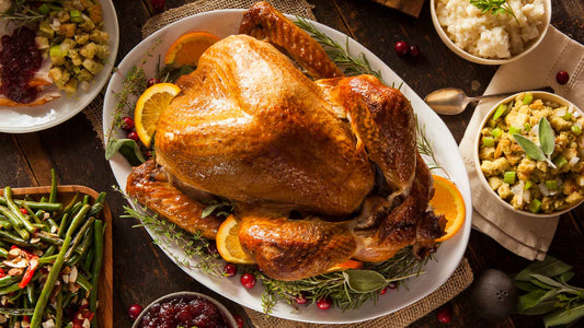 Roasted turkey with side dishes on a wooden table