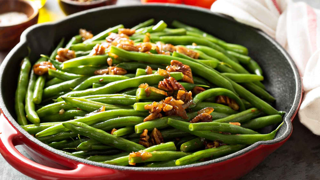 Green beans with pecans in a red skillet