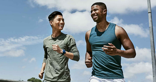 two men jogging outdoors on blue cloudy sky