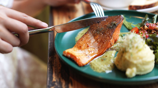 The Art of Mindful Eating | Person cutting into piece of salmon | Just Björn