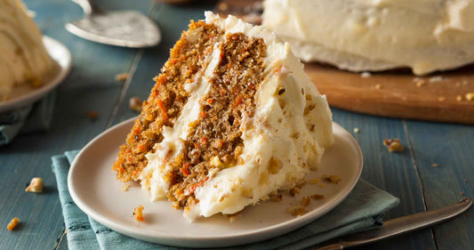 Slice of carrot cake with frosting on a plate