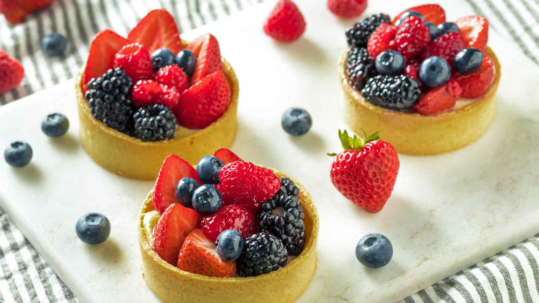 Mini berry tarts filled with creamy custard and topped with strawberries, blueberries, raspberries, and blackberries.