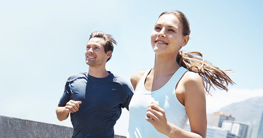 Man and woman in sports wear running side by side