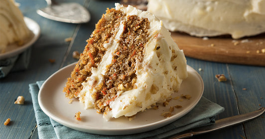 Slice of carrot cake with frosting on a plate