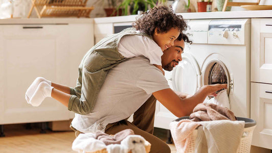 father and son doing laundry together