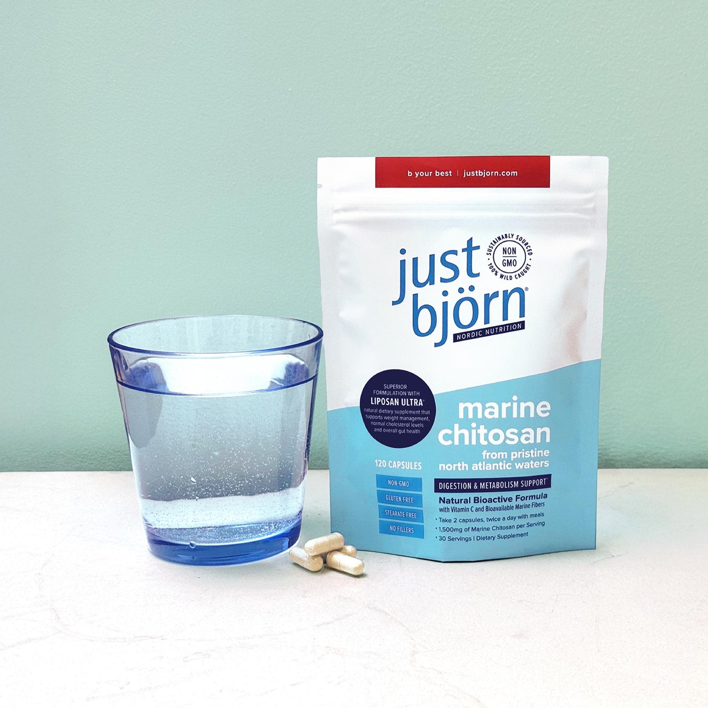 Just Björn Nordic Marine Chitosan capsules with glass of water for daily digestion and metabolism support