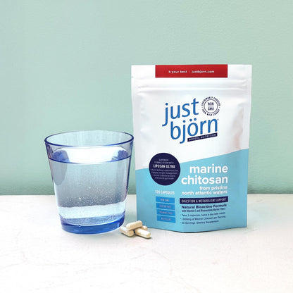 Just Björn Nordic Marine Chitosan capsules with glass of water for daily digestion and metabolism support