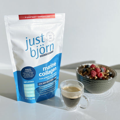 a pouch of just bjorn marine collagen with a cup of coffee and bowl of cereal with berries