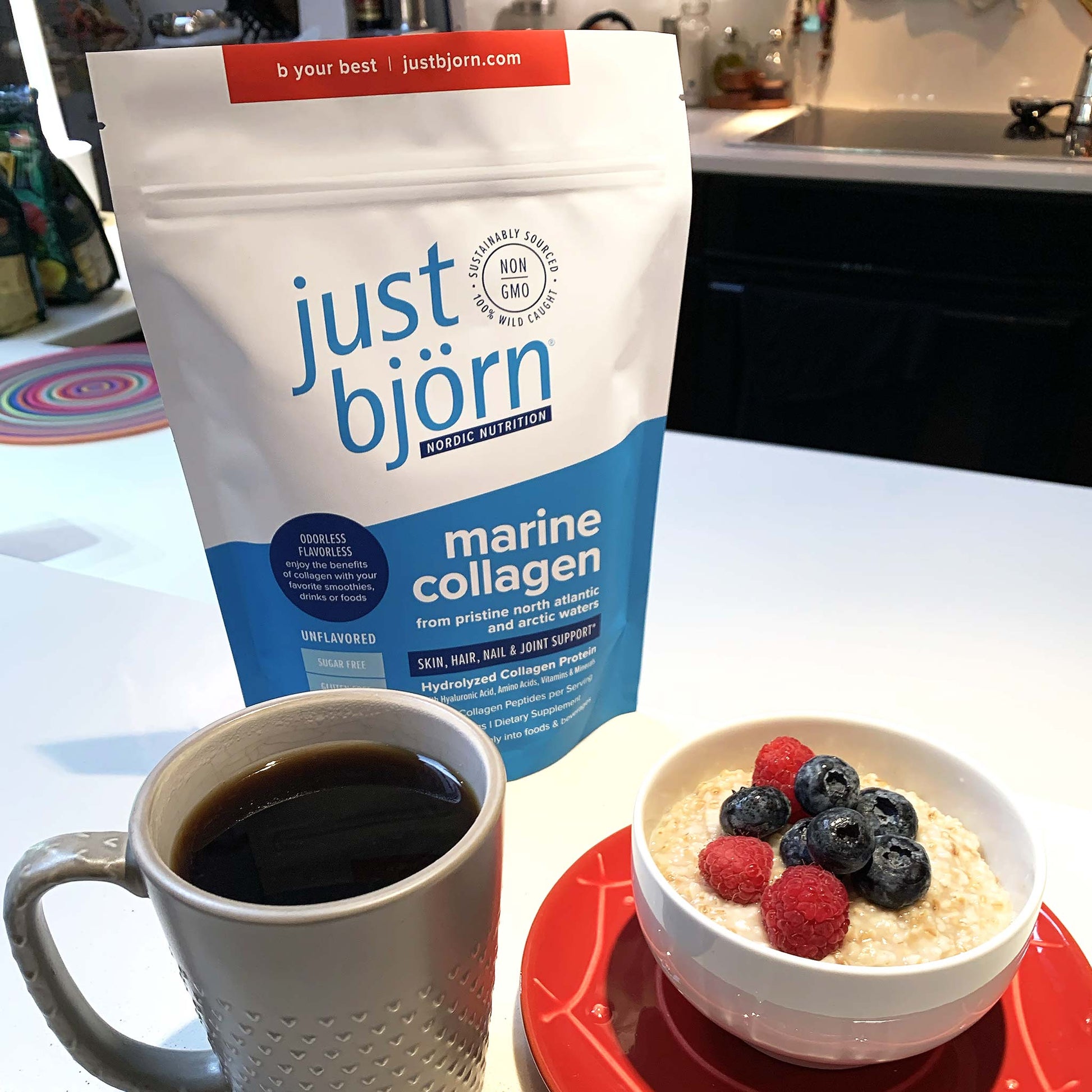 just bjorn marine collagen pouch with a cup of coffee and a bow of oatmeal with berries in a kitchen setting